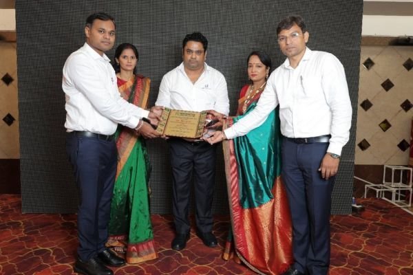 Rohit Jain with other guests on stage, holding a plaque presented as chief guest.