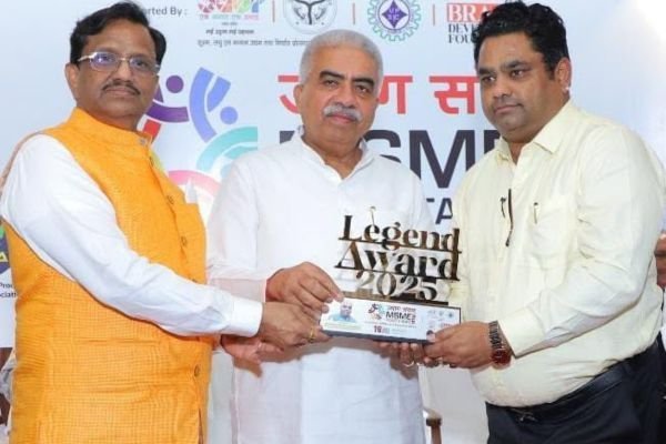 Rohit Jain receiving the Legend Award trophy from a guest in a white kurta at MSME Power Talk.