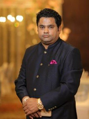 Rohit Jain, chairman of Ahinsa Group Agra, photographed in a dark bandhgala jacket.