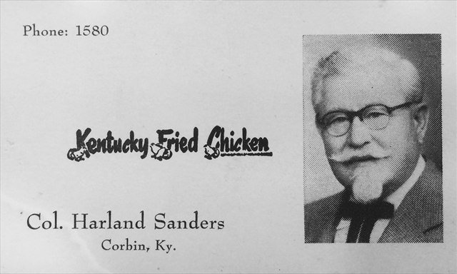 A Colonel Sanders business card reading Kentucky Fried Chicken, Col. Harland Sanders, Corbin, Ky., with his portrait on the right.