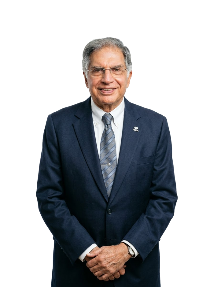 Ratan Tata in a navy suit and striped tie, wearing the Tata lapel pin, cut out from its background.