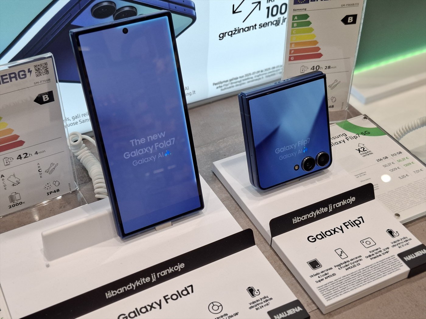A Samsung Galaxy Z Fold 7 and a Galaxy Z Flip 7 on display stands in a phone shop.