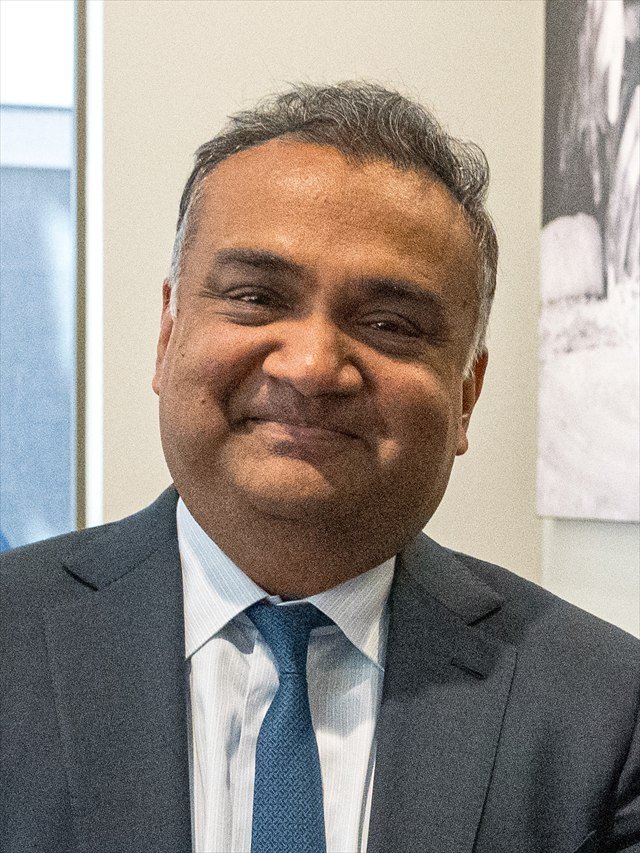 Neal Mohan, chief executive of YouTube, in a dark suit and tie, smiling, in New York in 2023.