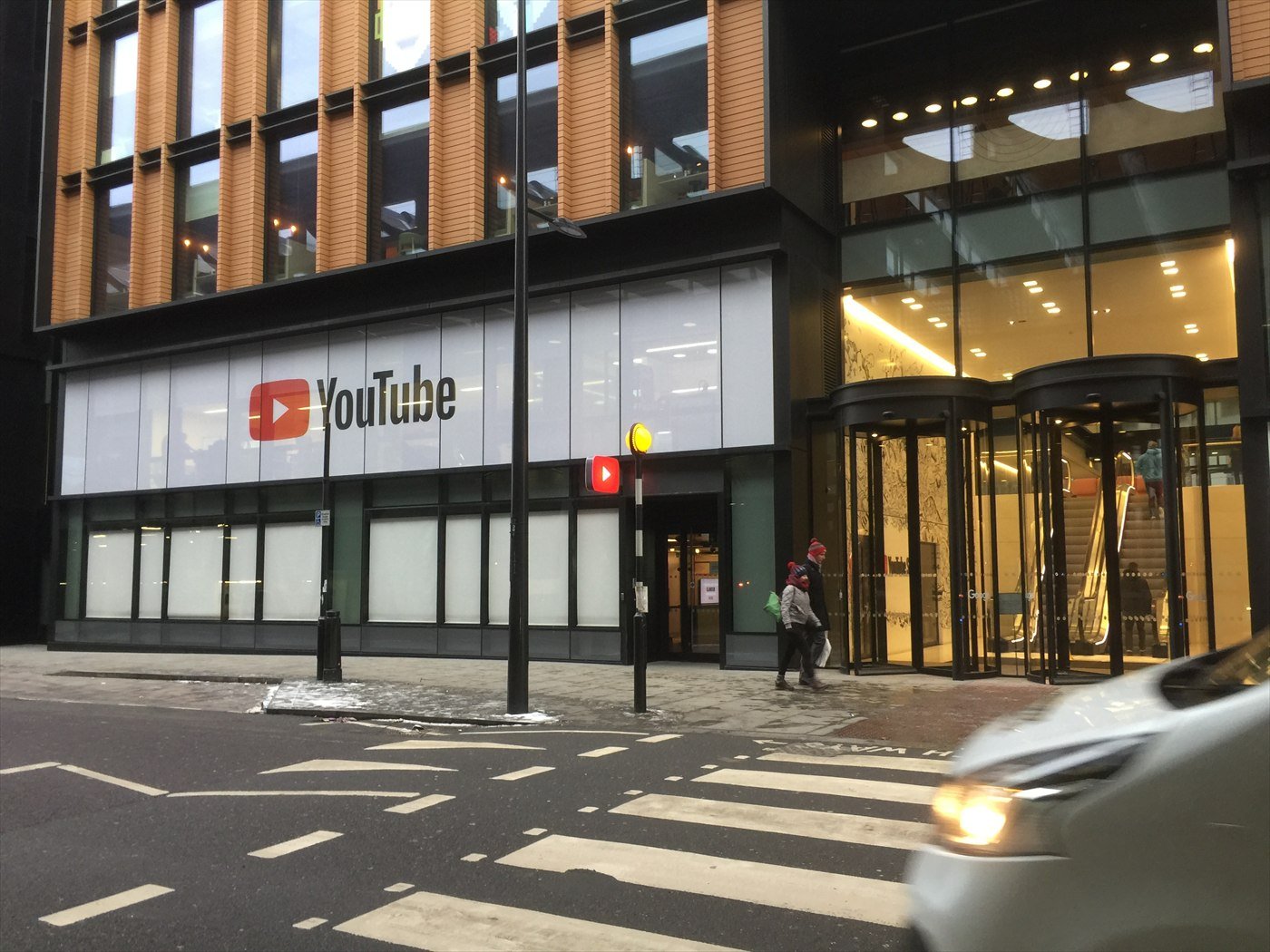 The glass front of the YouTube Space building near King’s Cross in London, with the YouTube logo above the entrance.