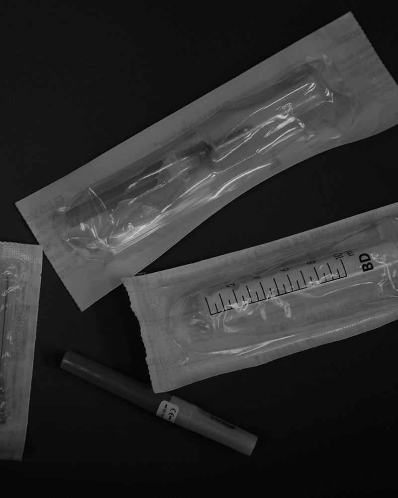 Sterile medical instruments laid out on a dark surface.