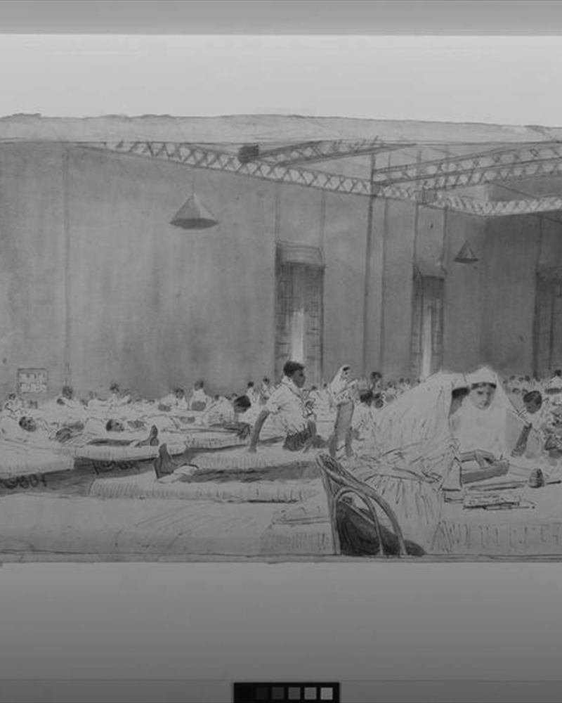 A long hospital ward lined with beds.