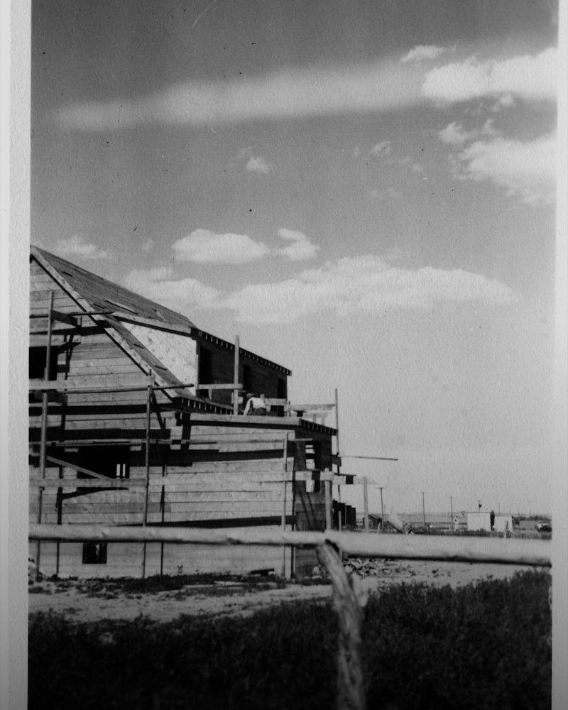 A timber and steel frame going up on a construction site.