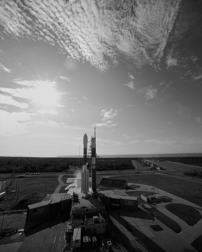 A rocket standing on its launch pad at dawn.